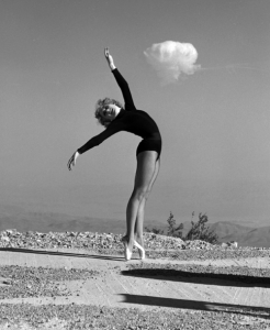 Showgirl Sally McCloskey does an "atomic ballet" in front of a shot.