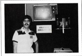 Joel with a single computer and a homemade sign at the June 1980 Origins gaming convention.