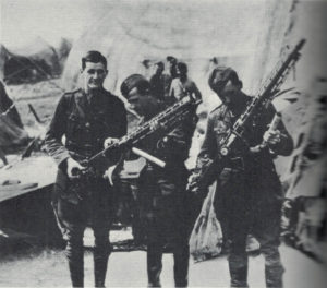 British soldiers carry souvenirs away from the wreckage of Manfred von Richthofen's airplane.